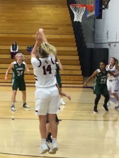 Edward Little’s Grace Fontaine puts up a three-point shot in second-half action Friday, Nov. 23, at the annual Gipper’s Tip-Off Classic. Waiting for results are, from left, the Hornet’s Carlie Leavitt and Julia White along with EL freshman Madisyn Turcotte. (Owen Galway photo)